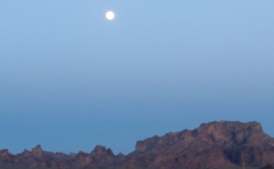 Moonrise over desert mountains